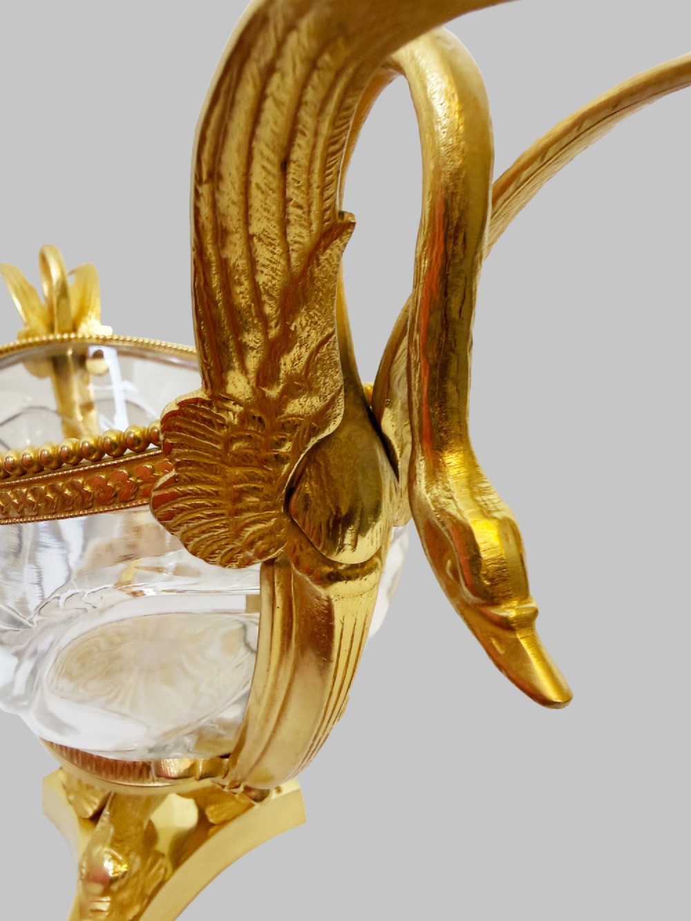 A 19th-century boat-shaped cut-crystal bowl with gilt-bronze swan-form handles and a pedestal base supported by gilt dolphins. View VI