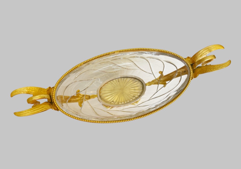 A 19th-century boat-shaped cut-crystal bowl with gilt-bronze swan-form handles and a pedestal base supported by gilt dolphins. View VII