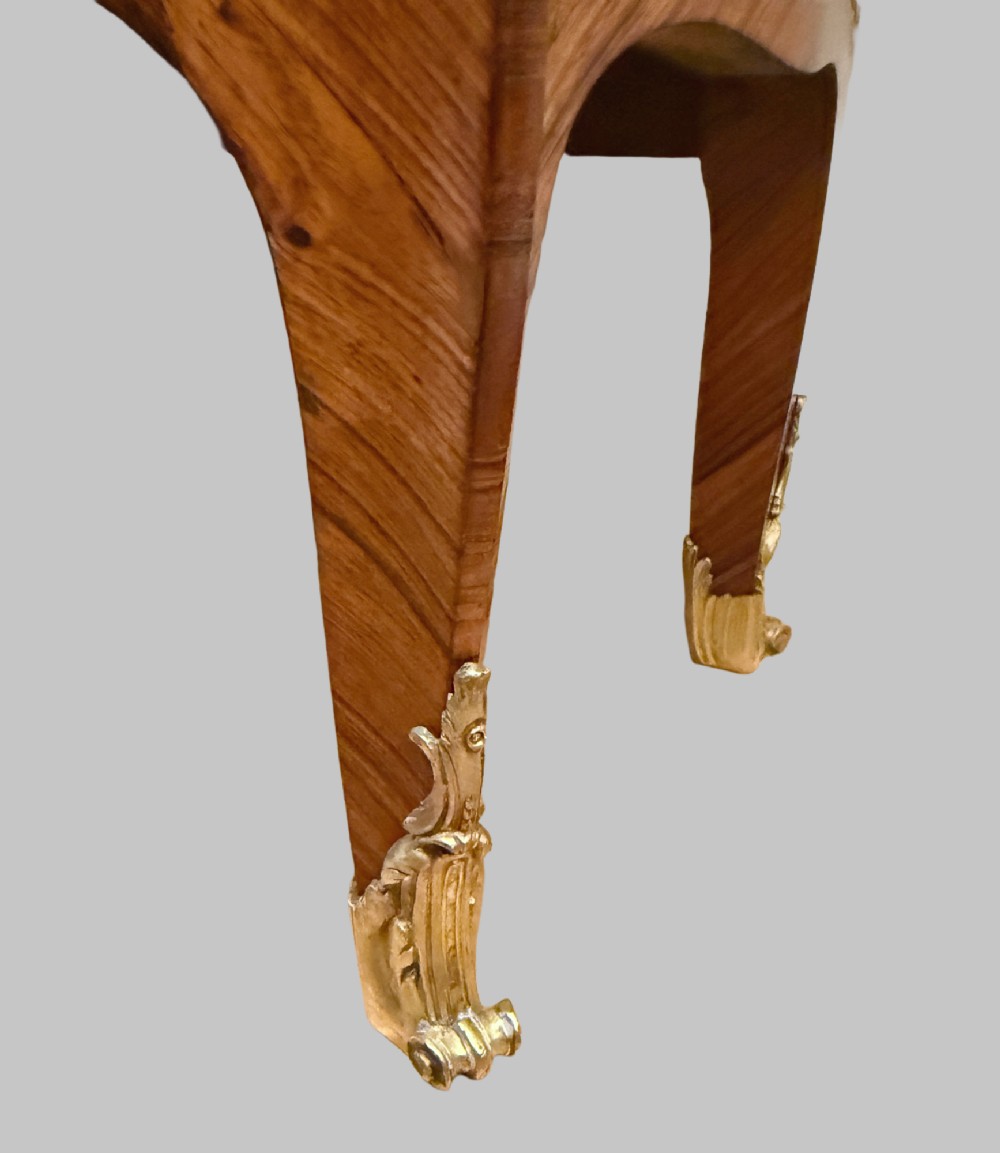 A late 19th-century French Louis XV style demilune open bookcase featuring marquetry wood veneer, gilt-bronze ormolu mounts, open shelving, and a glass vitrine top. View VII