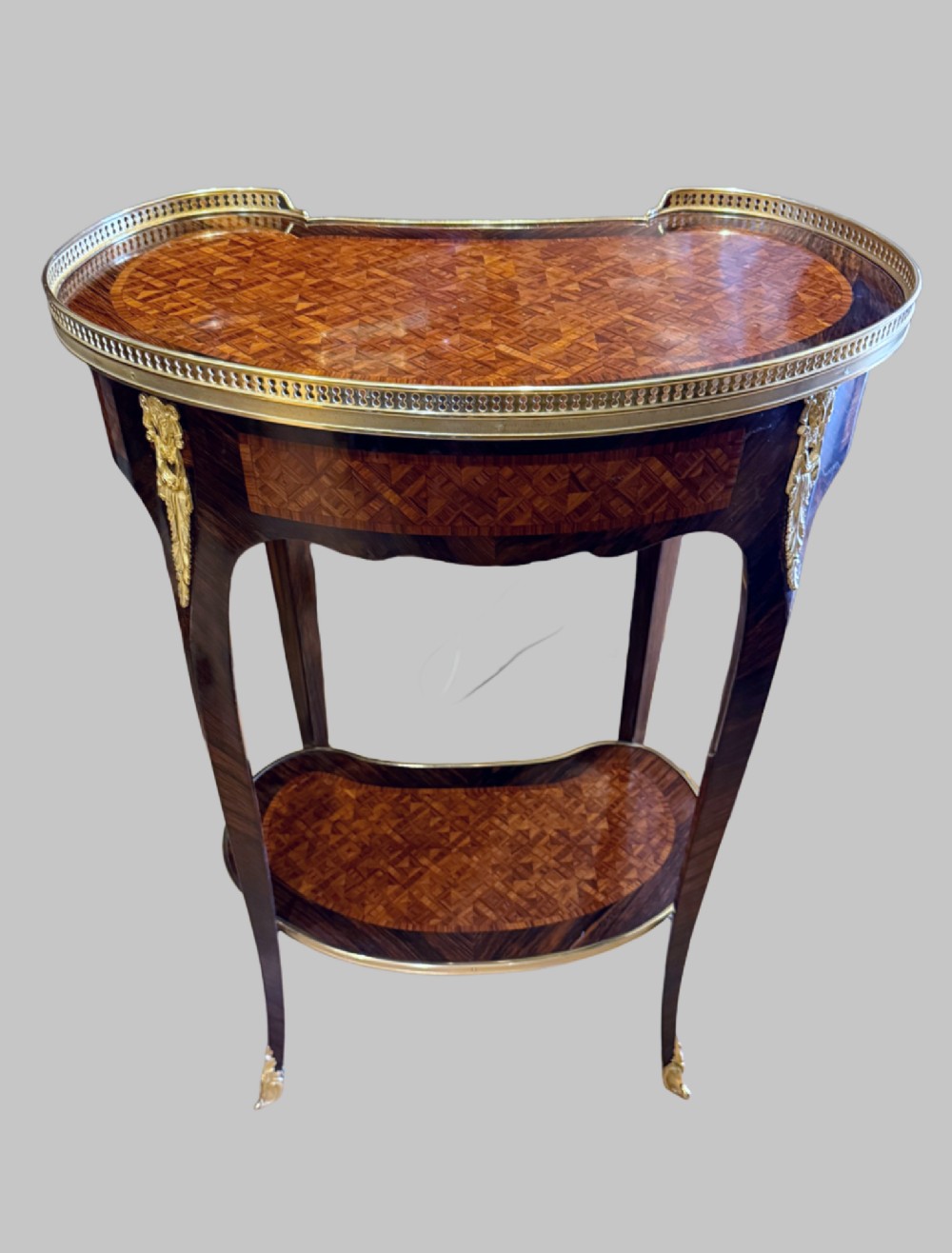 A nineteenth-century kidney-shaped side table with geometric parquetry inlay, a pierced brass gallery rim, and ormolu mounts on cabriole legs. View II