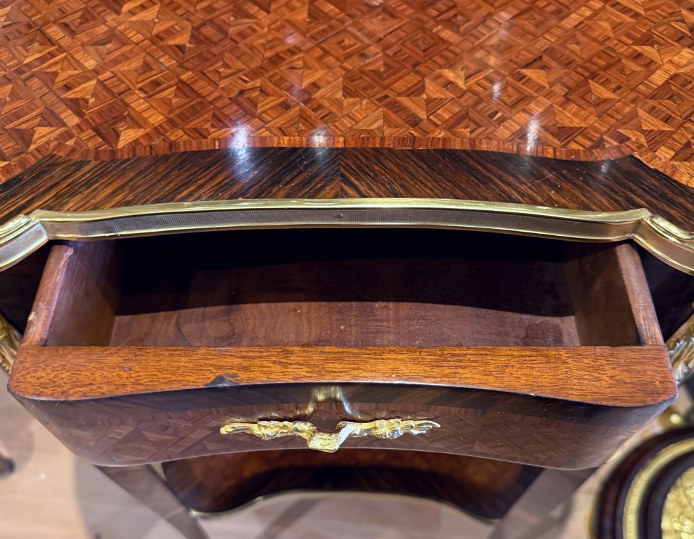 A nineteenth-century kidney-shaped side table with geometric parquetry inlay, a pierced brass gallery rim, and ormolu mounts on cabriole legs. View IV