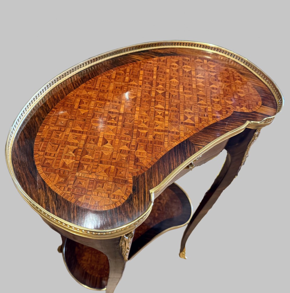 A nineteenth-century kidney-shaped side table with geometric parquetry inlay, a pierced brass gallery rim, and ormolu mounts on cabriole legs. View VI