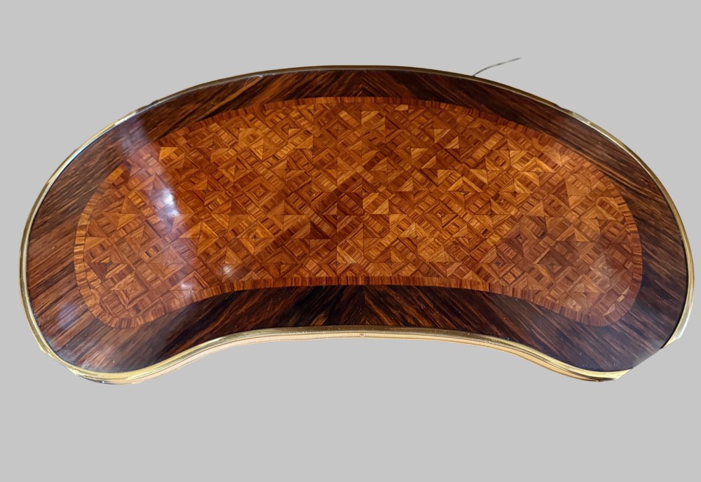 A nineteenth-century kidney-shaped side table with geometric parquetry inlay, a pierced brass gallery rim, and ormolu mounts on cabriole legs. View VII