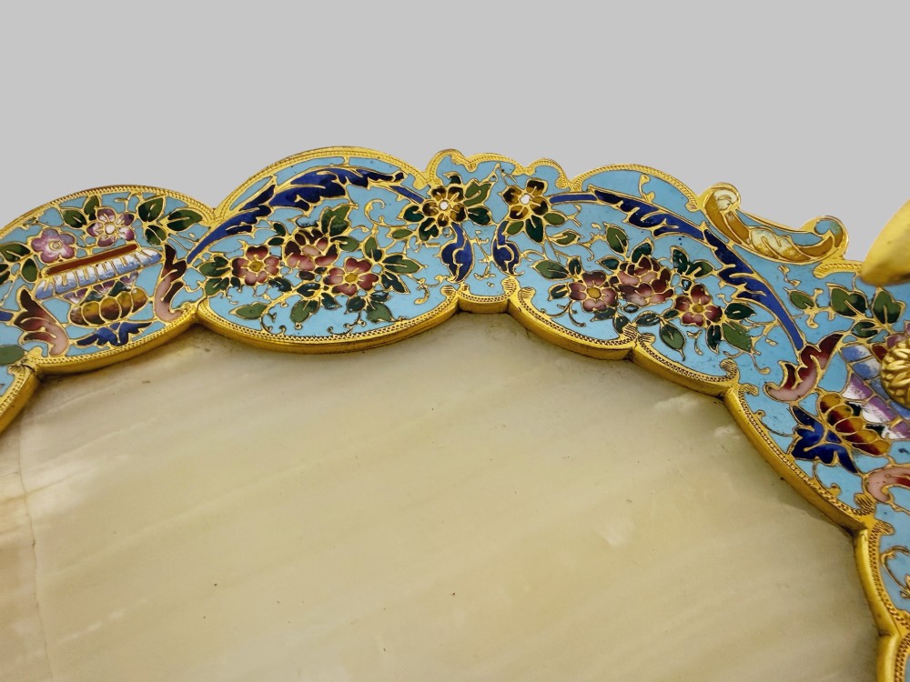 An antique French gilt bronze centrepiece tray featuring a scalloped rim with light blue floral champleve enamel work, an onyx inset base, and an ornate scroll handle. View V