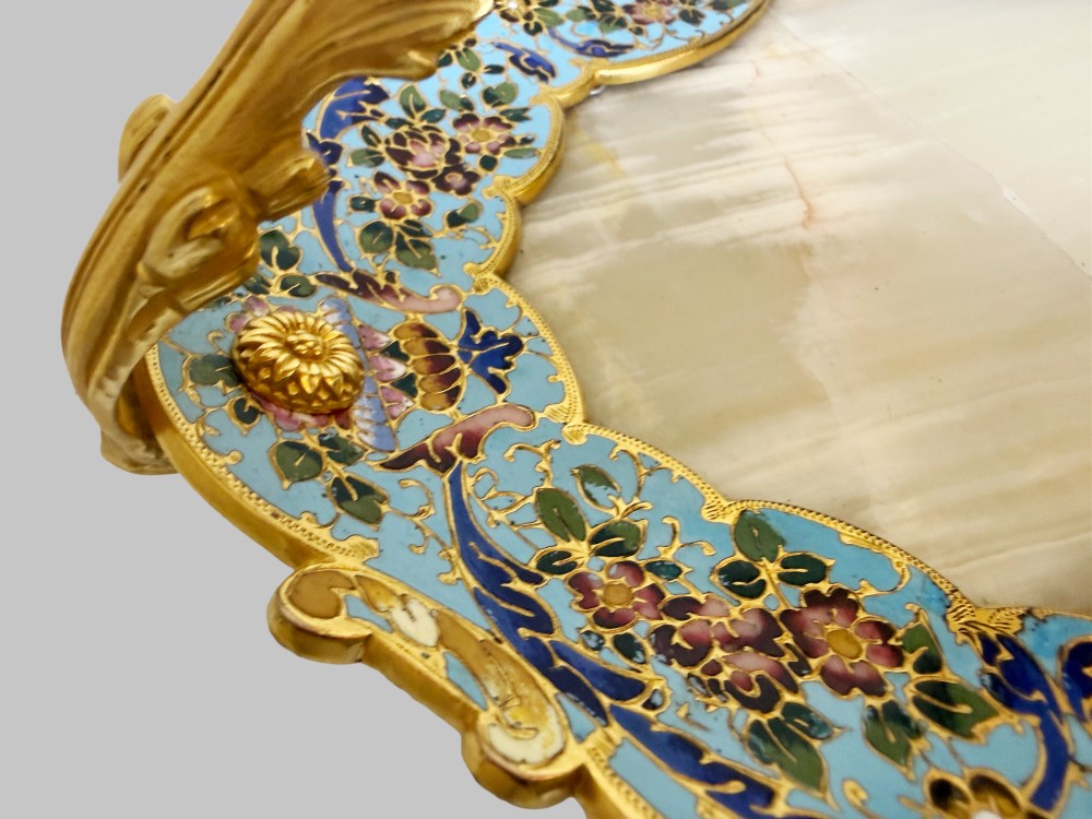 An antique French gilt bronze centrepiece tray featuring a scalloped rim with light blue floral champleve enamel work, an onyx inset base, and an ornate scroll handle. View VI