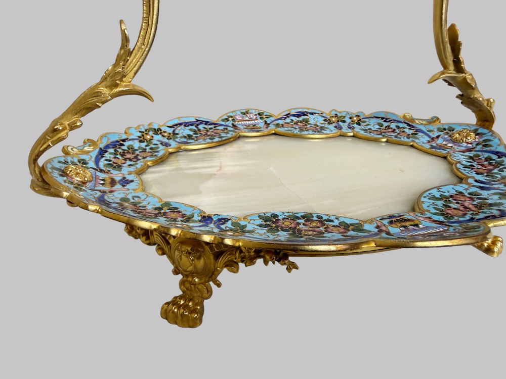 An antique French gilt bronze centrepiece tray featuring a scalloped rim with light blue floral champleve enamel work, an onyx inset base, and an ornate scroll handle. View VII