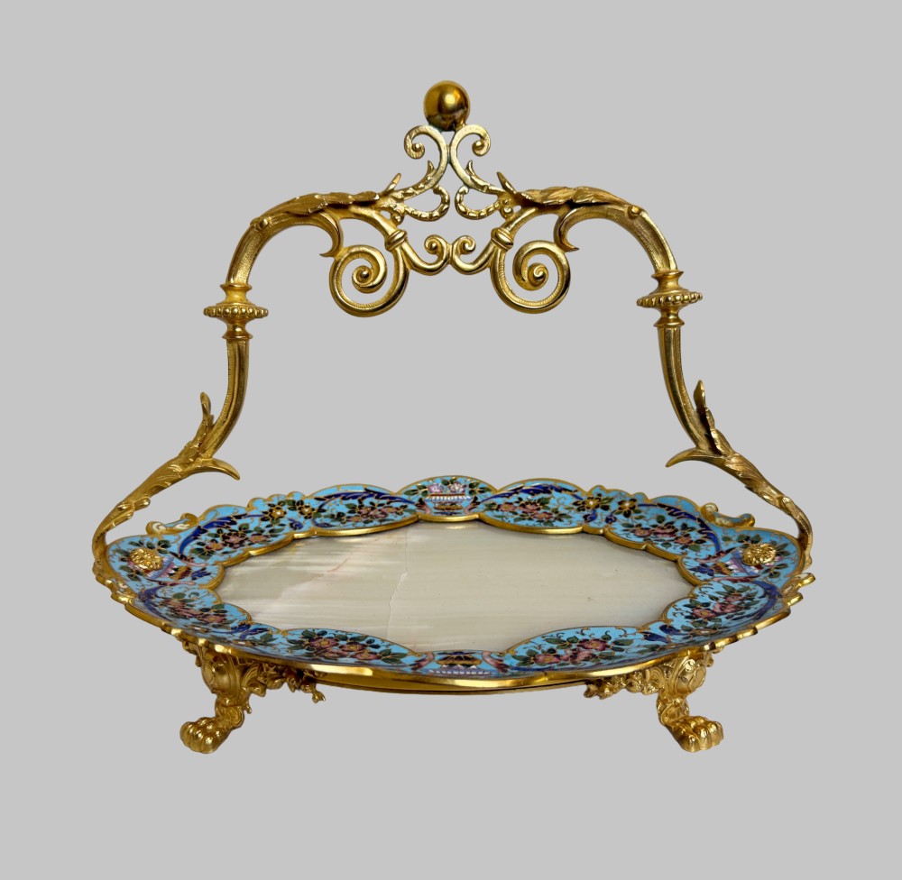 An antique French gilt bronze centrepiece tray featuring a scalloped rim with light blue floral champleve enamel work, an onyx inset base, and an ornate scroll handle. View VIII