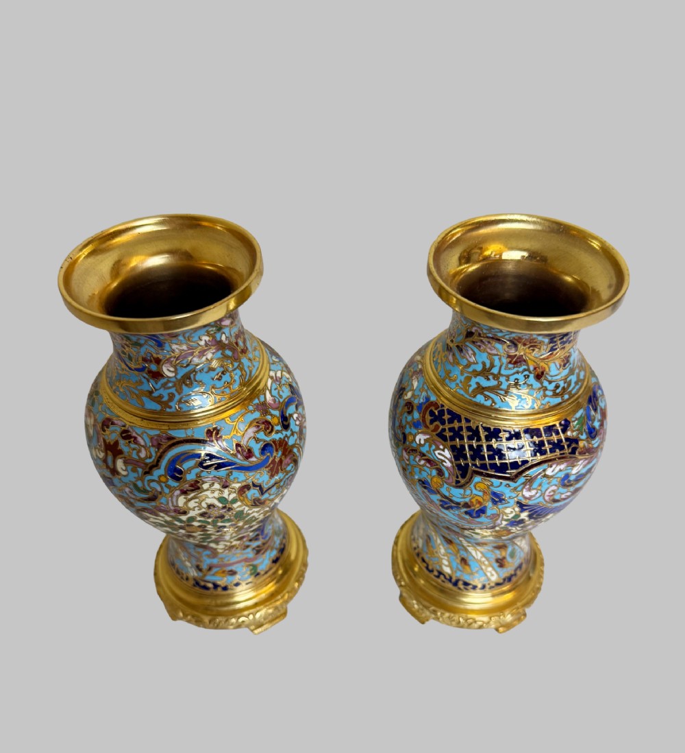 A pair of 19th-century French gilt bronze urn-shaped vases decorated with intricate turquoise and polychrome champleve enamel scrollwork. View II