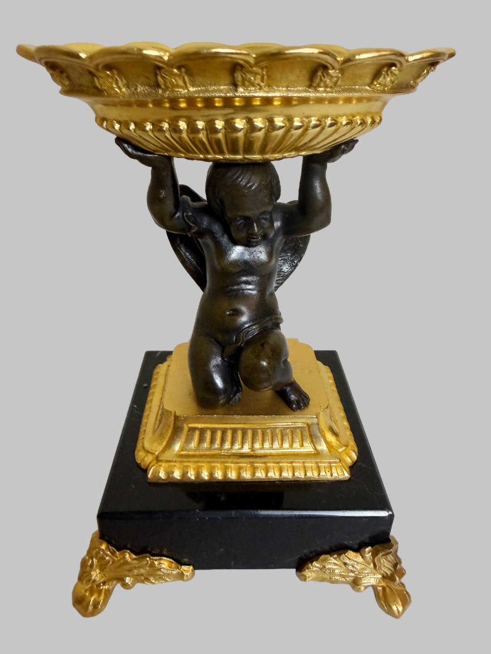 A pair of nineteenth-century gilt bronze and black marble tazzas featuring dark bronze winged cherub figures supporting fluted shallow bowls. View VII