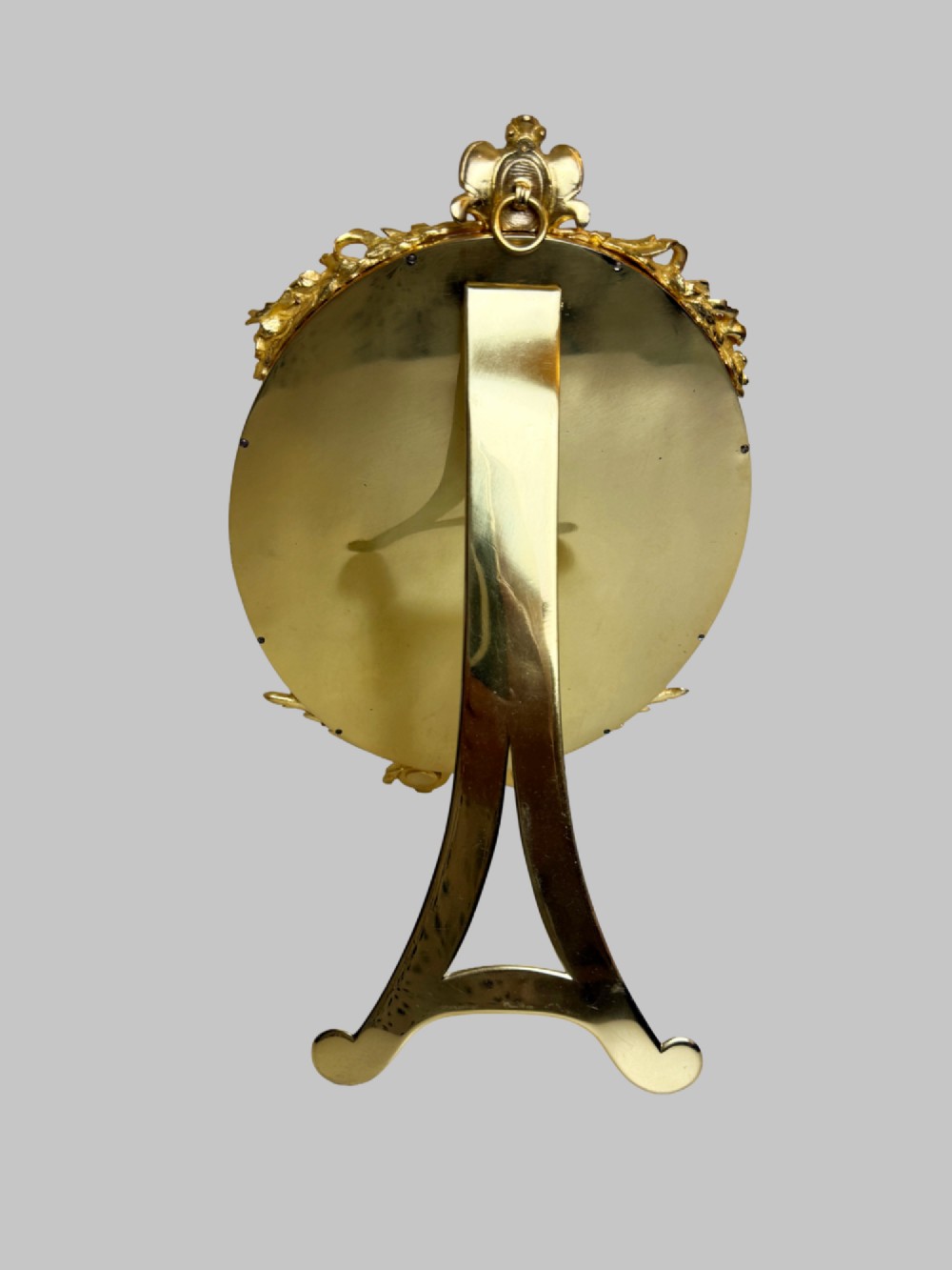 A late 19th-century oval dressing table mirror featuring a gilt bronze frame adorned with blue and purple champleve enamel and bird motifs. View IV
