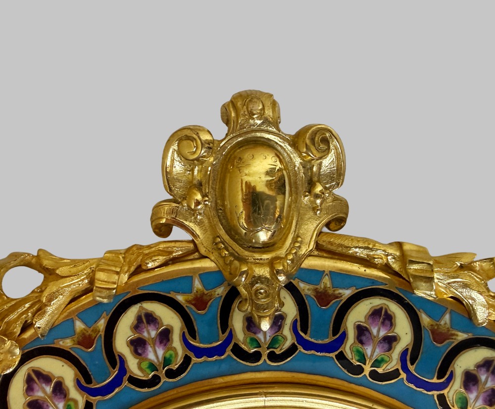 A late 19th-century oval dressing table mirror featuring a gilt bronze frame adorned with blue and purple champleve enamel and bird motifs. View VIII
