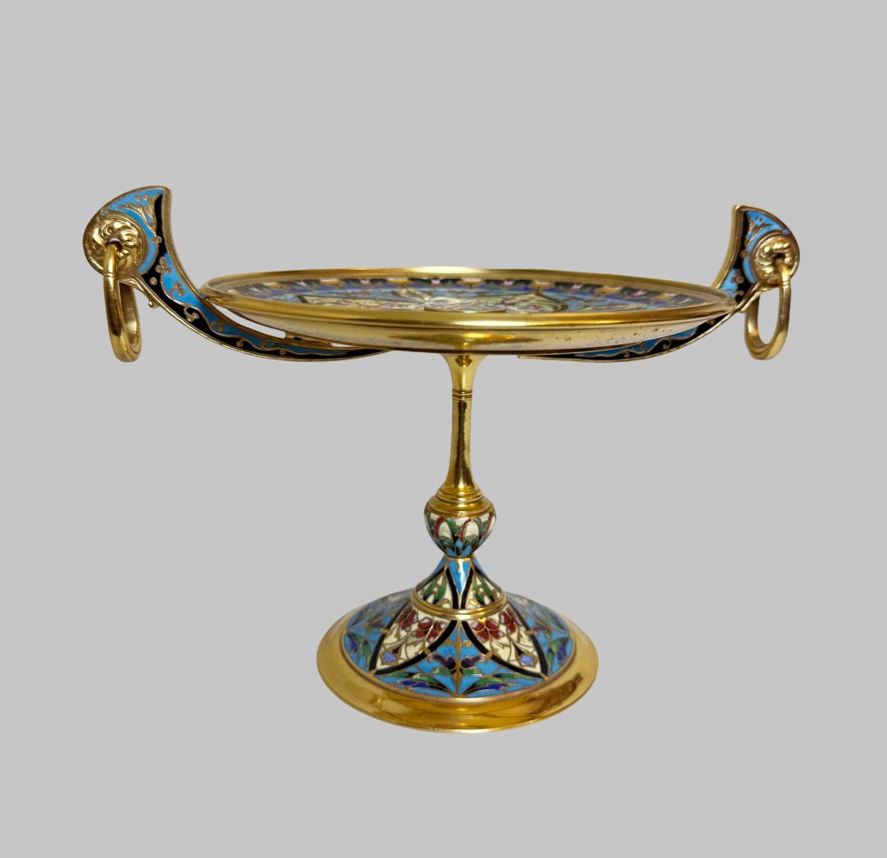A 19th-century gilt bronze tazza featuring polychrome champleve enamel inlay across the shallow dish, pedestal foot, and side handles. View VII