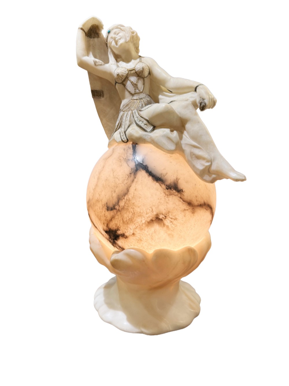 An Art Deco carved alabaster sculpture featuring a female dancer posed atop an illuminated marble orb resting on a shell-shaped pedestal base.