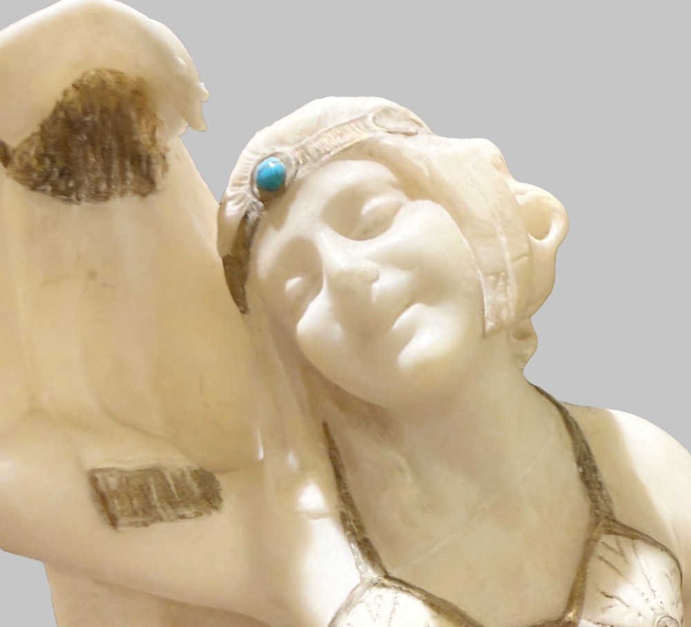 An Art Deco carved alabaster sculpture featuring a female dancer posed atop an illuminated marble orb resting on a shell-shaped pedestal base. View V