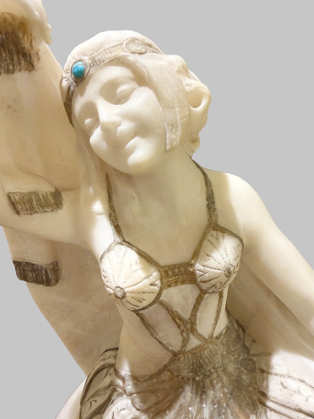 An Art Deco carved alabaster sculpture featuring a female dancer posed atop an illuminated marble orb resting on a shell-shaped pedestal base. View VI