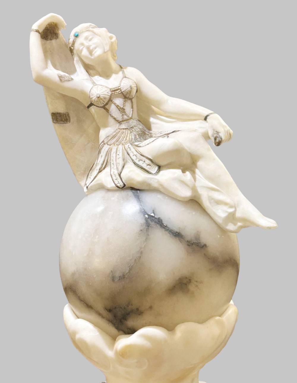 An Art Deco carved alabaster sculpture featuring a female dancer posed atop an illuminated marble orb resting on a shell-shaped pedestal base. View VIII