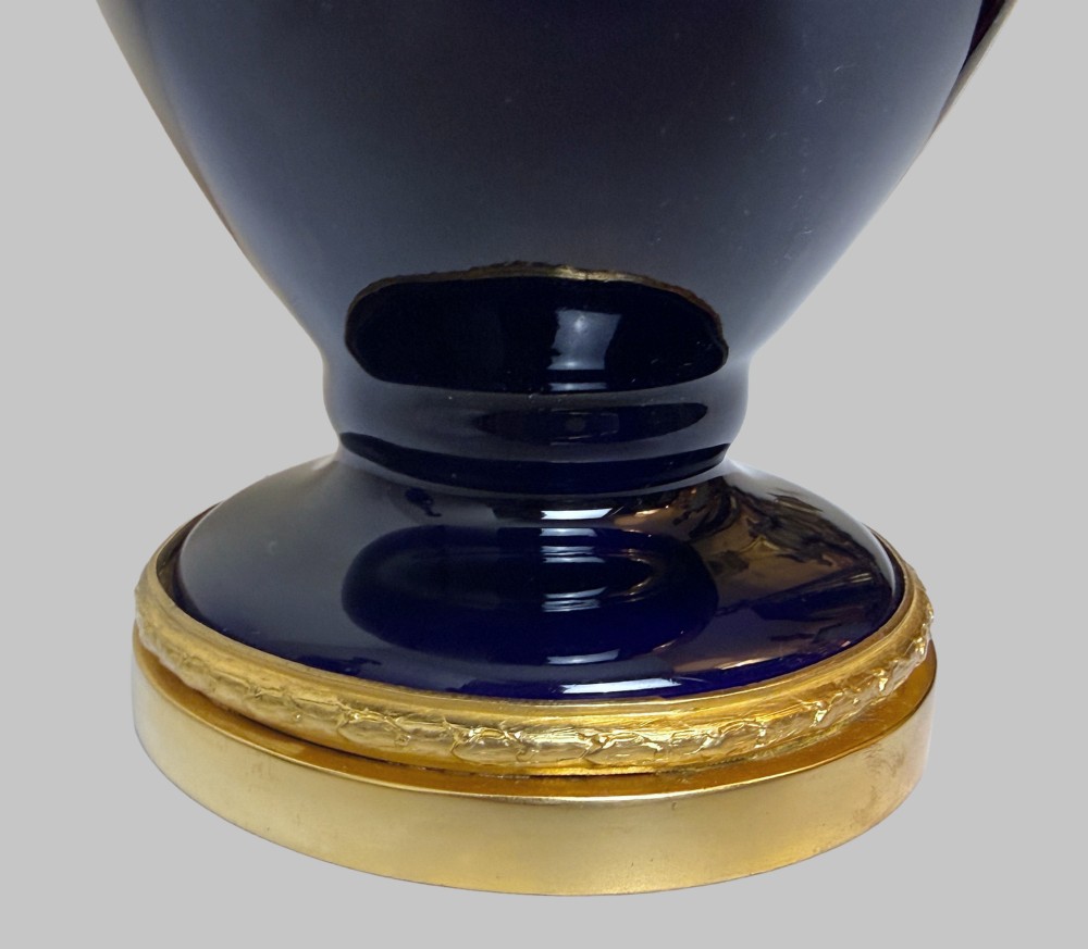 A pair of 19th-century deep cobalt blue porcelain vases decorated with gilt bronze floral garland swags and gilded rim bases. View III
