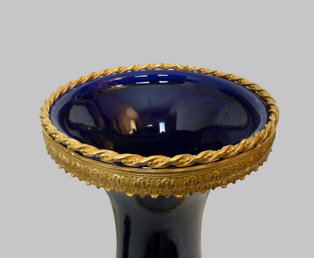 A pair of 19th-century deep cobalt blue porcelain vases decorated with gilt bronze floral garland swags and gilded rim bases. View IV
