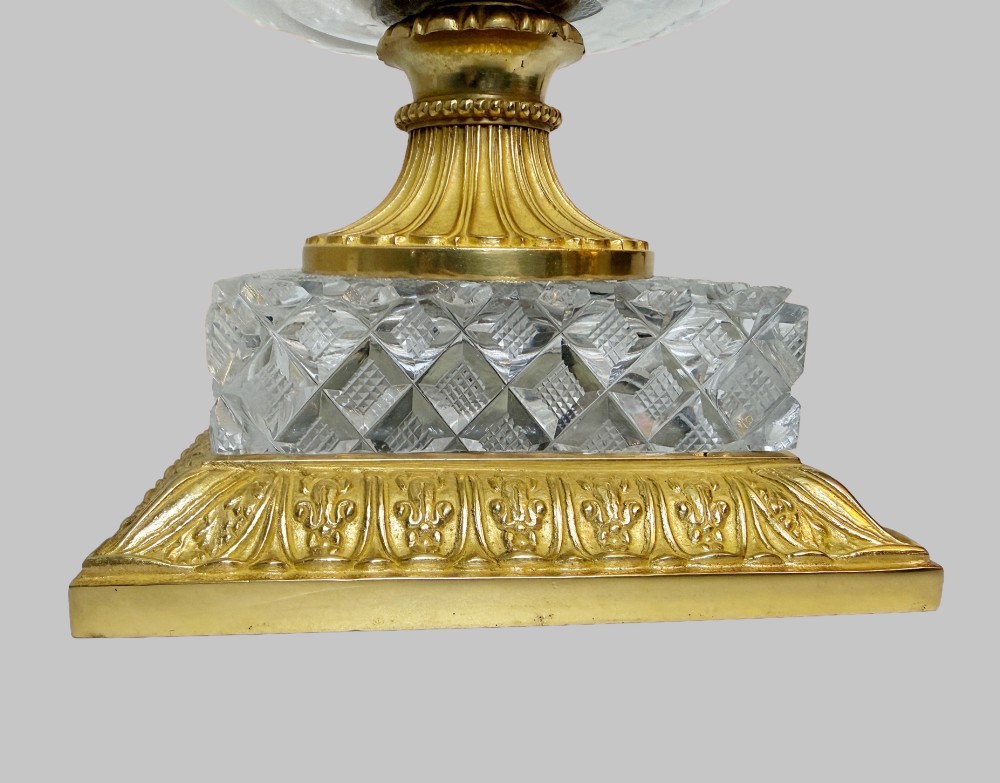 A clear cut-crystal urn-shaped vase featuring fluted body detailing, diamond-pattern cutting, and a gilt bronze rim and square pedestal base. View II