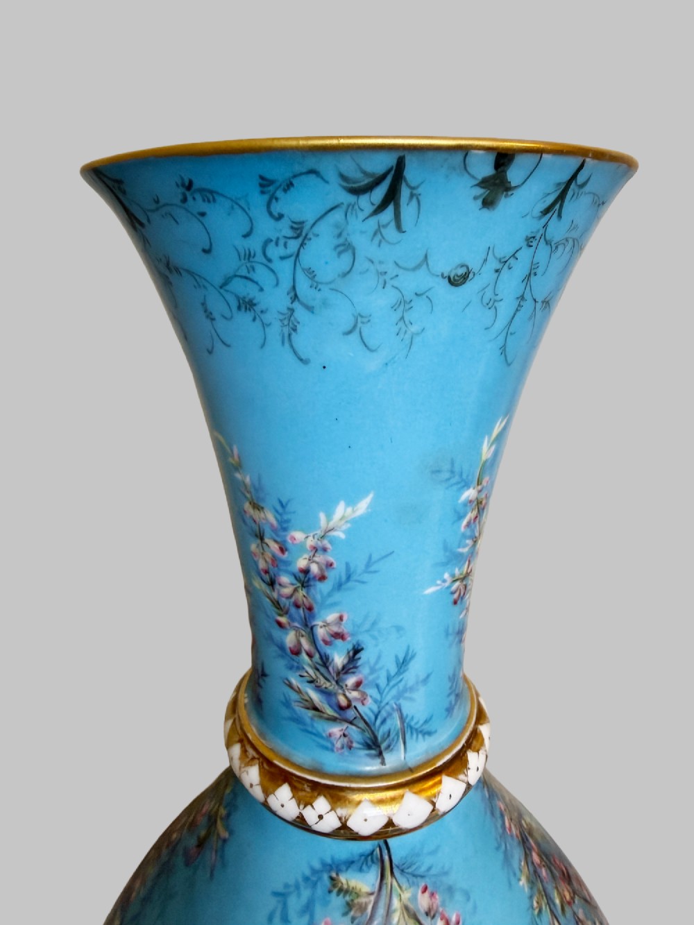 A pair of tall sky blue porcelain vases with bulbous bases, hand-painted floral branch motifs, and gilded rims and pedestals. View III