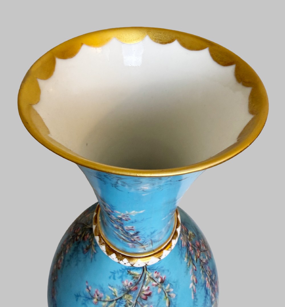 A pair of tall sky blue porcelain vases with bulbous bases, hand-painted floral branch motifs, and gilded rims and pedestals. View IV