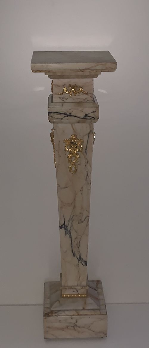 fig 1. A tapered beige veined marble pedestal stand featuring ornate gilt bronze mounts and a square swivel top set upon a stepped base.