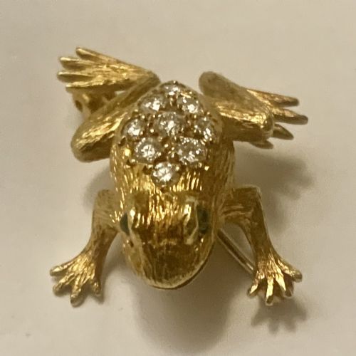 fig 1. A textured gold frog brooch set with diamonds along its back and green gemstone eyes.