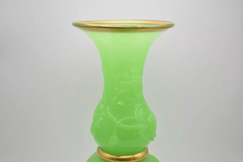 fig 2. A pair of apple green opaline glass vases with raised botanical leaf designs and gilded rims.