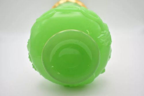 fig 3. A pair of apple green opaline glass vases with raised botanical leaf designs and gilded rims.
