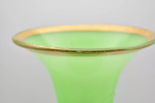 fig 4. A pair of apple green opaline glass vases with raised botanical leaf designs and gilded rims.