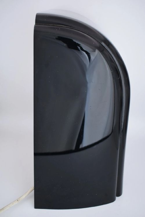 fig 2. An Art Deco black Bakelite electric clock featuring a chrome chapter ring beneath an illuminated diorama window with a moving ship model.