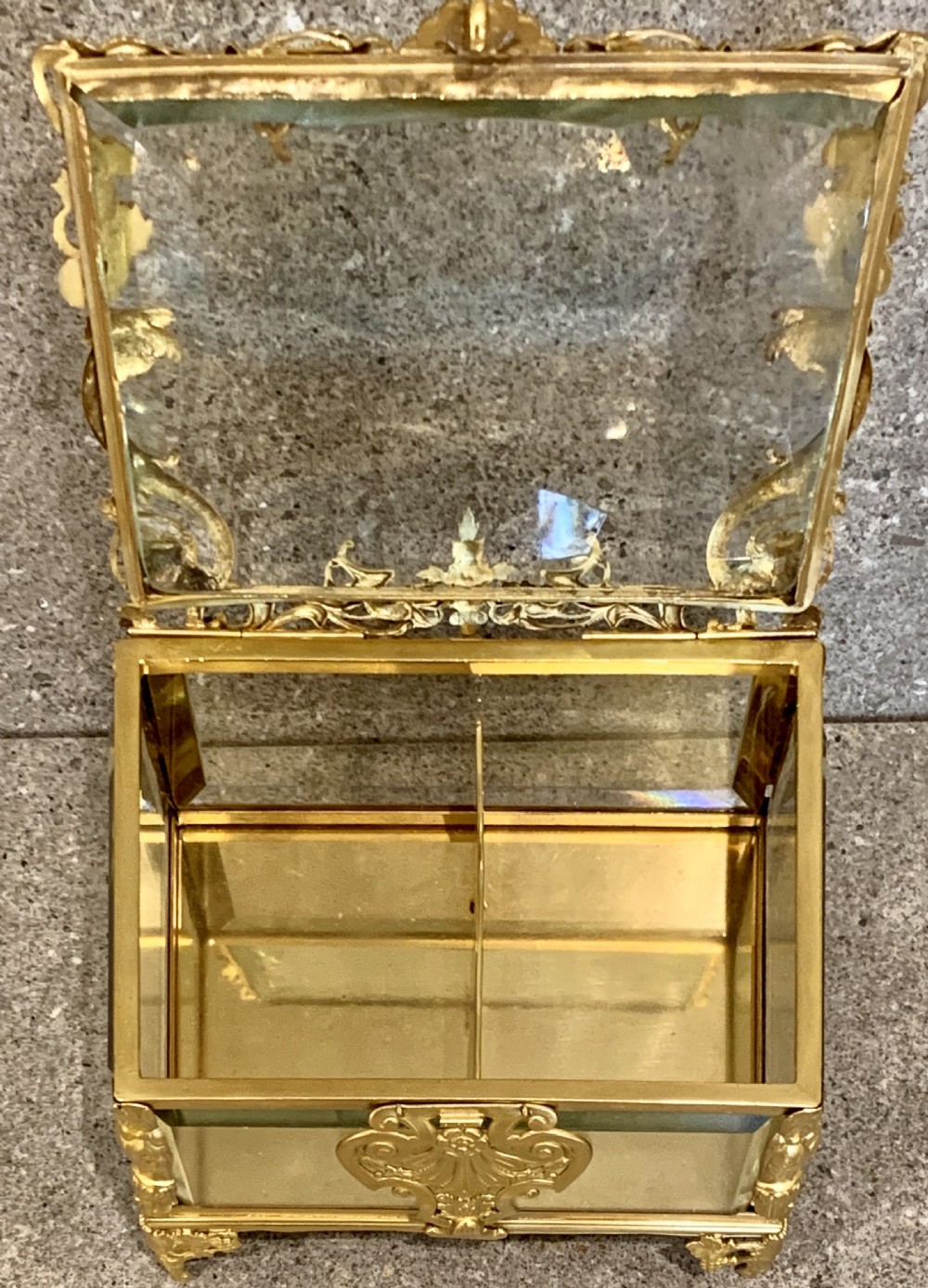A rectangular clear bevelled glass casket box featuring intricate French Napoleon III style gilt ormolu metal mounts, a shell motif clasp, and decorative scroll feet. View VIII