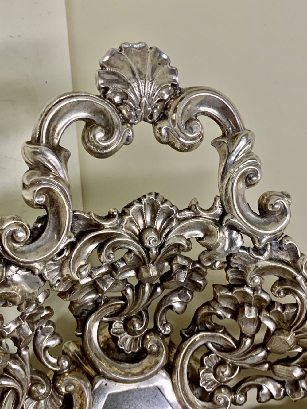 An oval antique silver basket featuring intricate openwork scrollwork, foliage motifs, and two integrated side handles. View VII