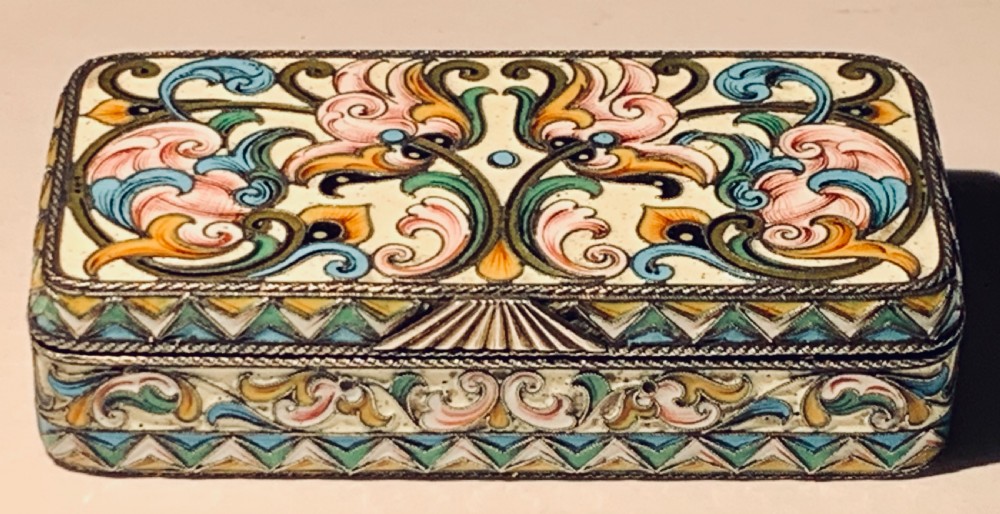 A rectangular Imperial Russian silver-gilt box decorated with floral multi-coloured shaded enamel over a cream background. View V
