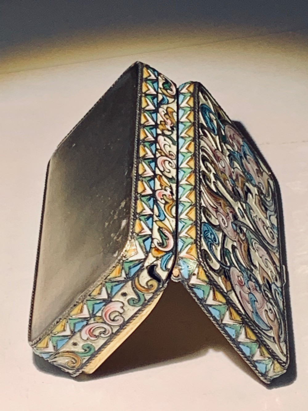 A rectangular Imperial Russian silver-gilt box decorated with floral multi-coloured shaded enamel over a cream background. View XI