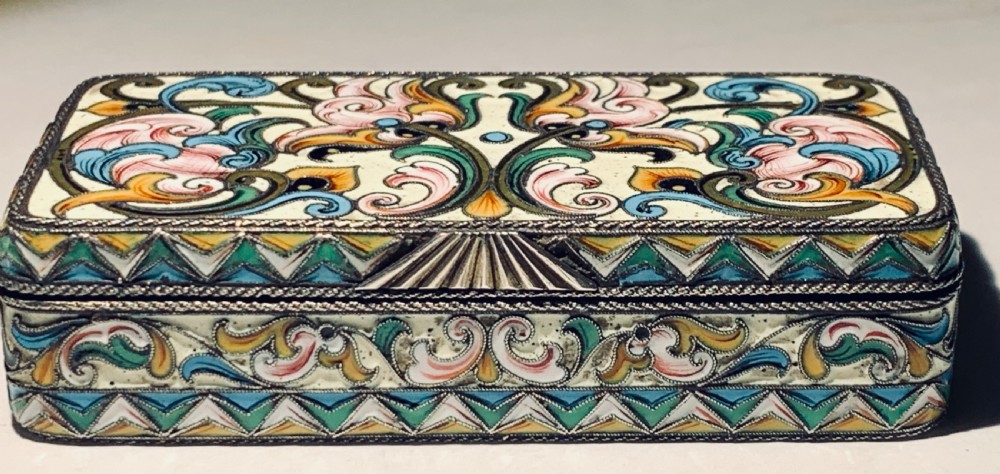 A rectangular Imperial Russian silver-gilt box decorated with floral multi-coloured shaded enamel over a cream background. View XIV