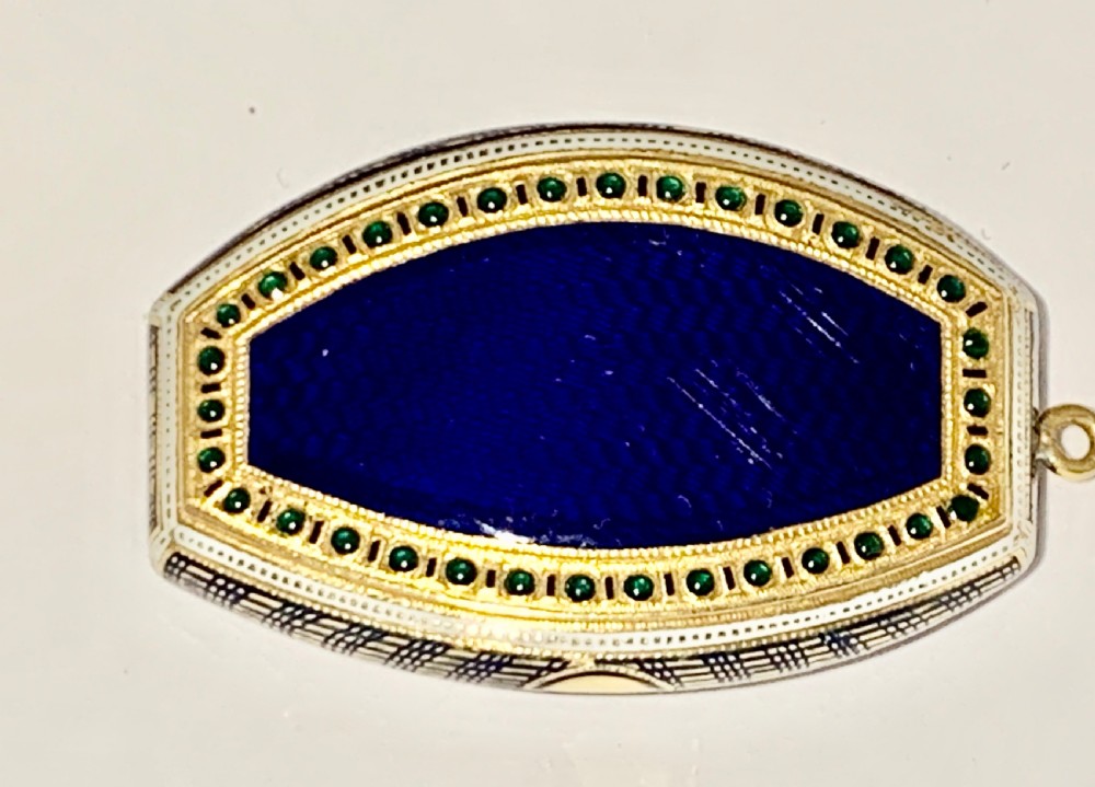 A late 18th-century oval gold vinaigrette box with a central royal blue enamel panel decorated with a shell motif and bordered by green stone accents. View XVIII