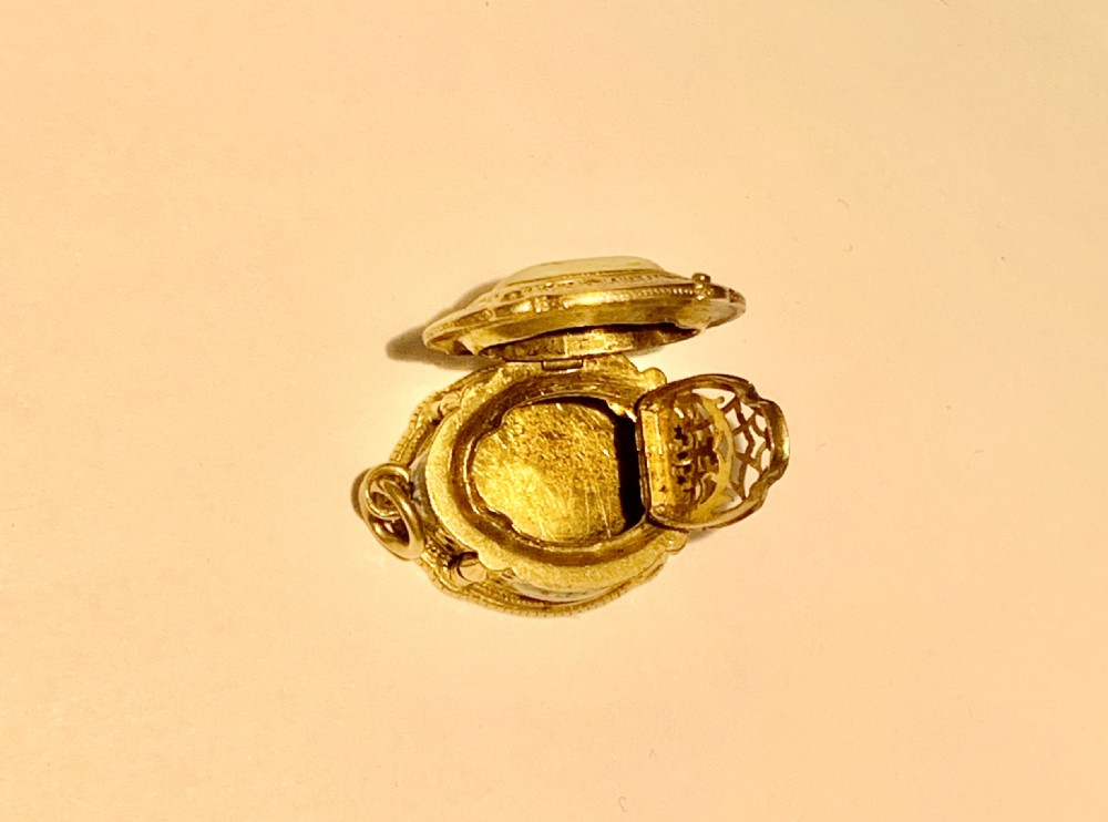 A GOLD AND ENAMEL VINAIGRETTE BOX PENDANT CHARM. View IX