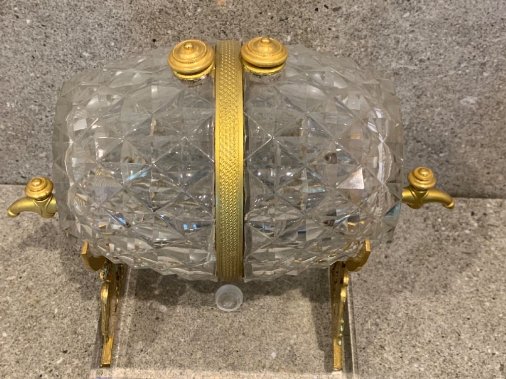 A French Charles X cut crystal glass barrel with gilt bronze swan-form mounts and an integrated tap set on a clear glass base. View III