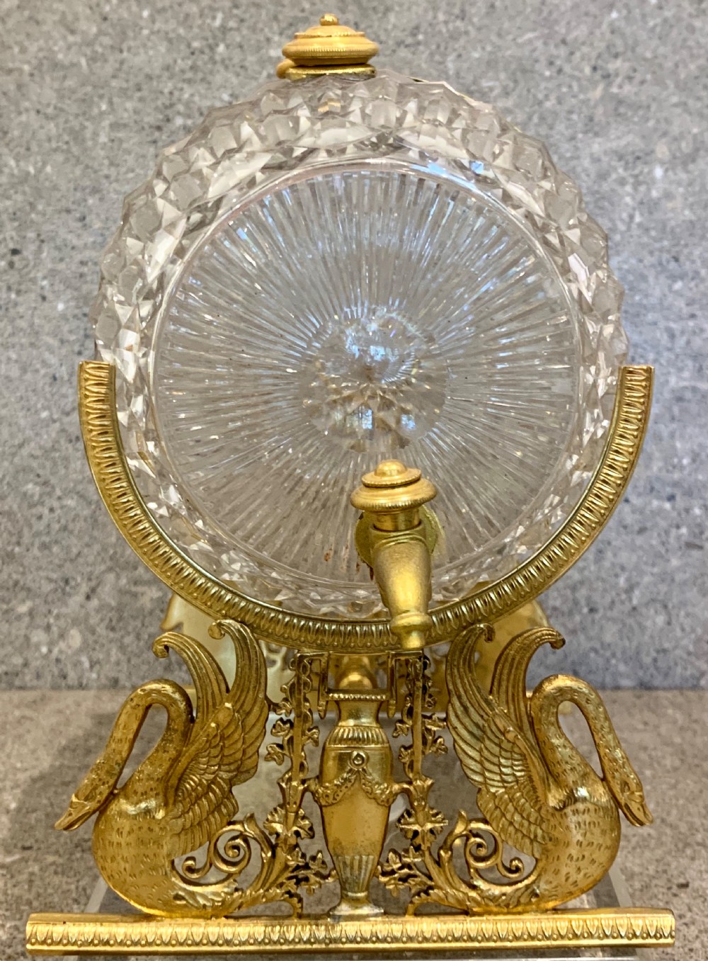 A French Charles X cut crystal glass barrel with gilt bronze swan-form mounts and an integrated tap set on a clear glass base. View IV