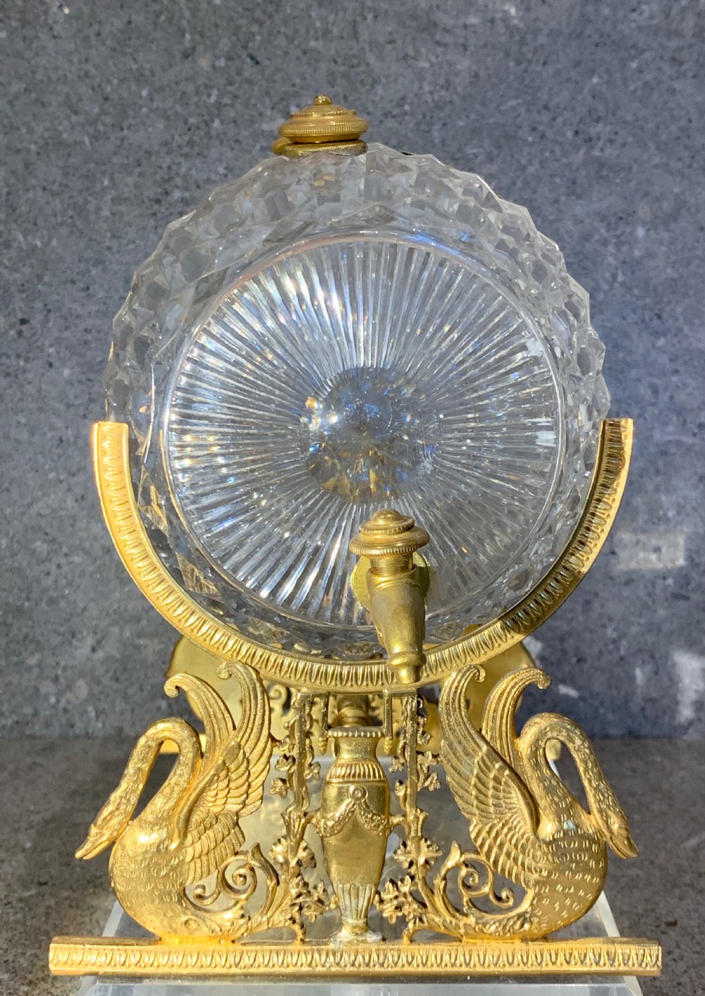 A French Charles X cut crystal glass barrel with gilt bronze swan-form mounts and an integrated tap set on a clear glass base. View V