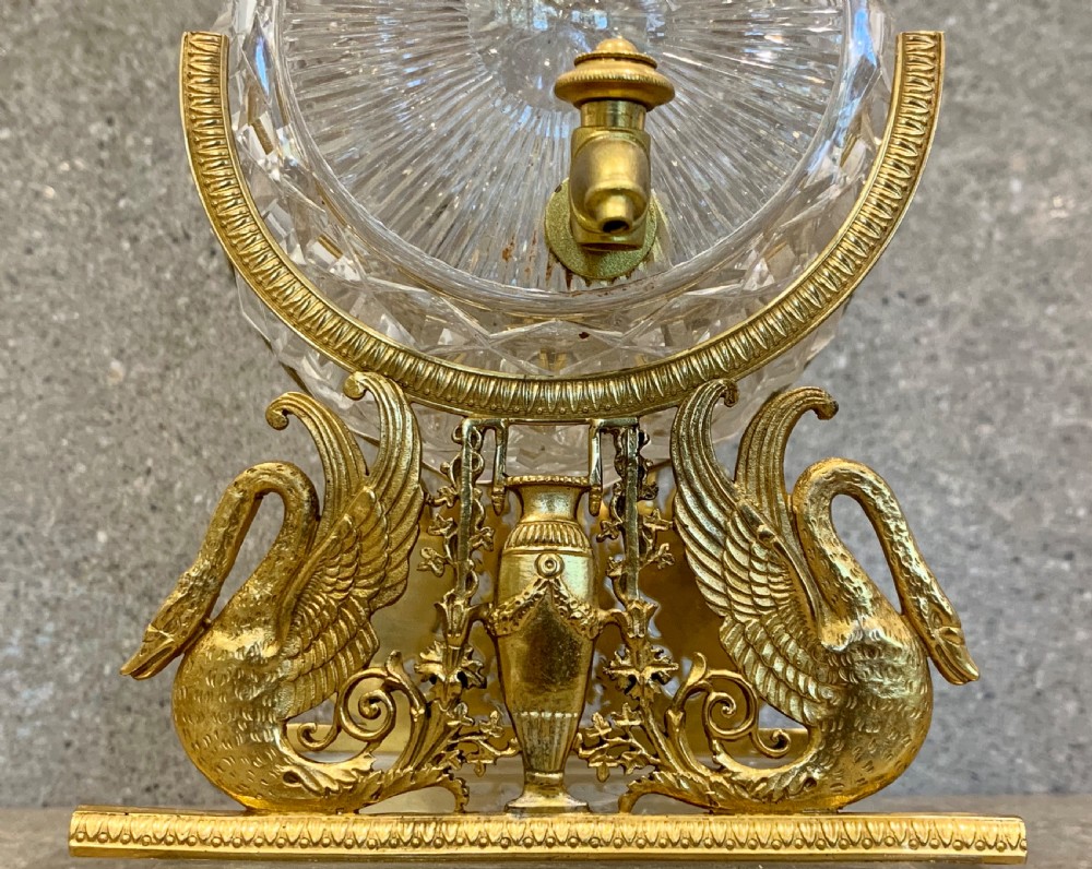 A French Charles X cut crystal glass barrel with gilt bronze swan-form mounts and an integrated tap set on a clear glass base. View IX