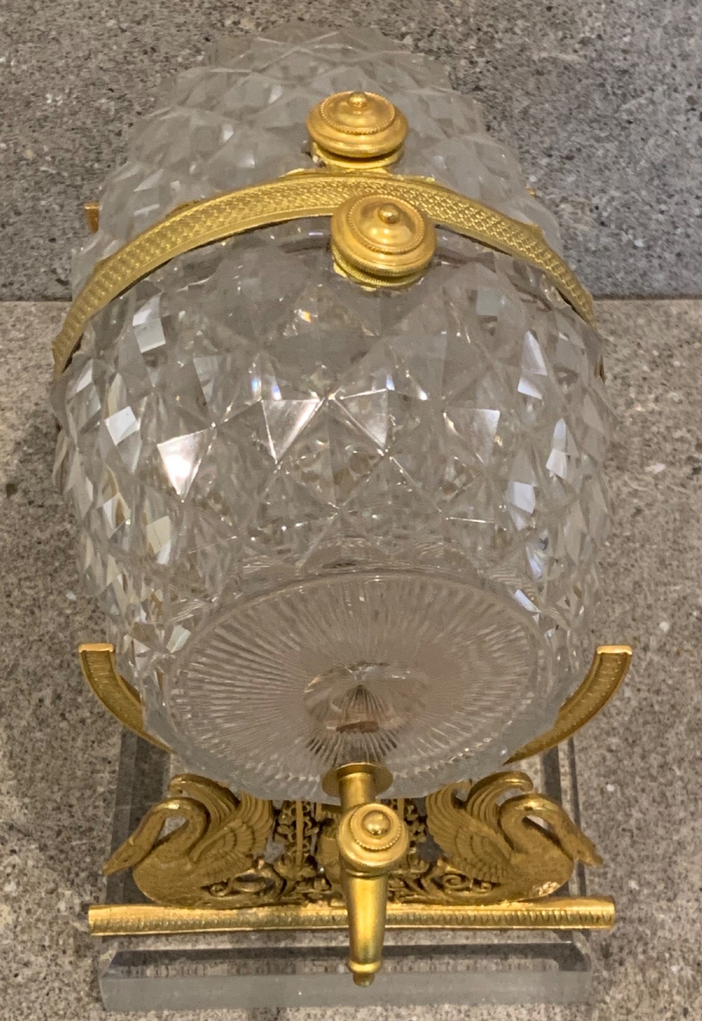 A French Charles X cut crystal glass barrel with gilt bronze swan-form mounts and an integrated tap set on a clear glass base. View X