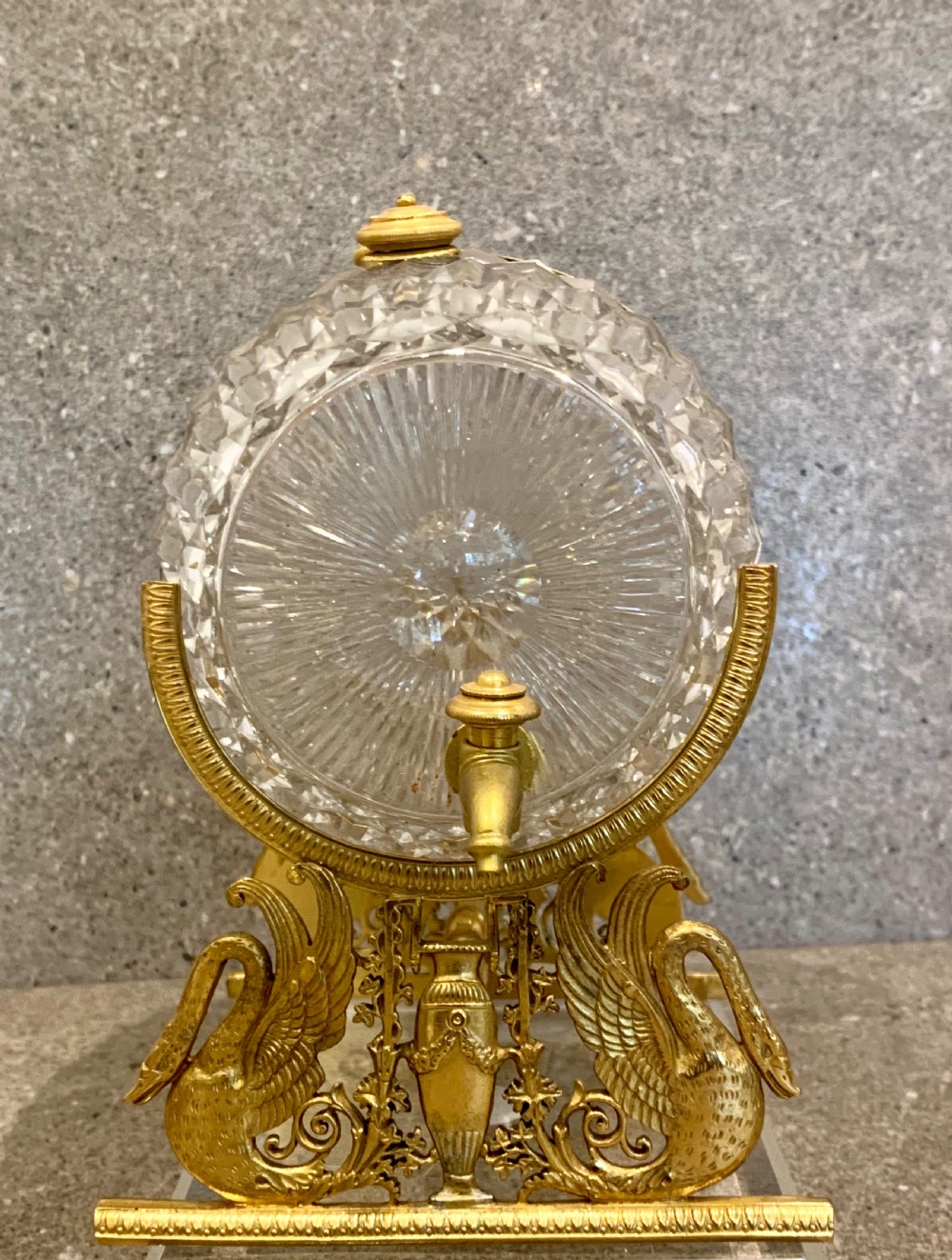 A French Charles X cut crystal glass barrel with gilt bronze swan-form mounts and an integrated tap set on a clear glass base. View XI