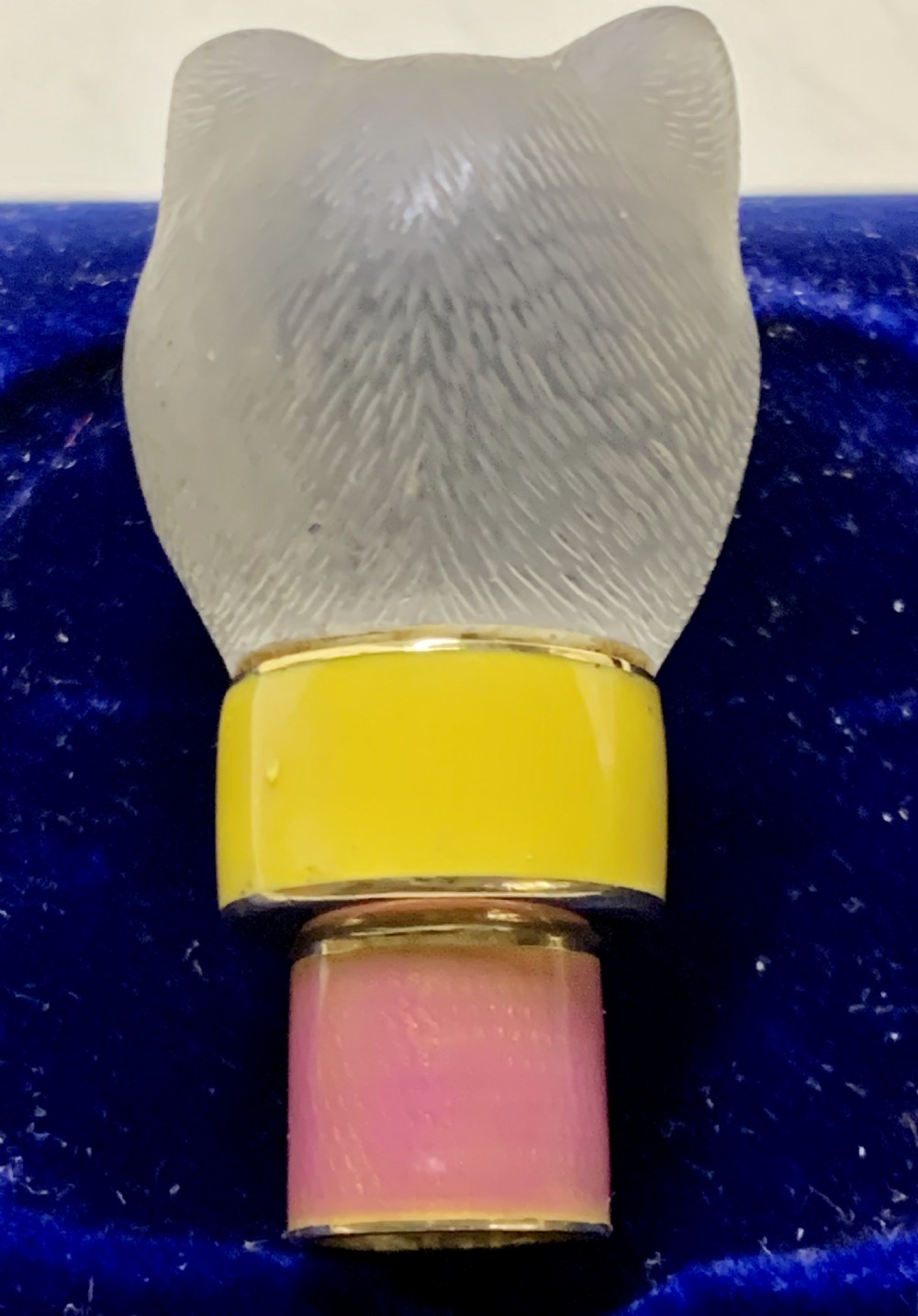 A carved frosted rock crystal cat head featuring green eyes, mounted atop an 18k gold collar with yellow and pink guilloche enamel. View VIII