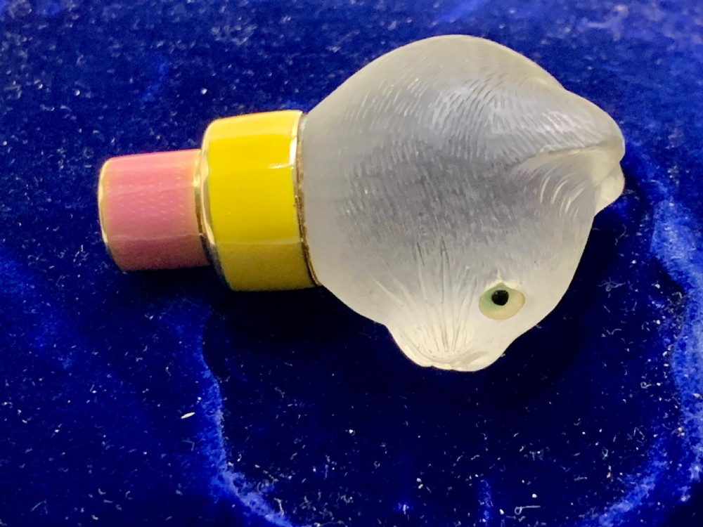 A carved frosted rock crystal cat head featuring green eyes, mounted atop an 18k gold collar with yellow and pink guilloche enamel. View XI