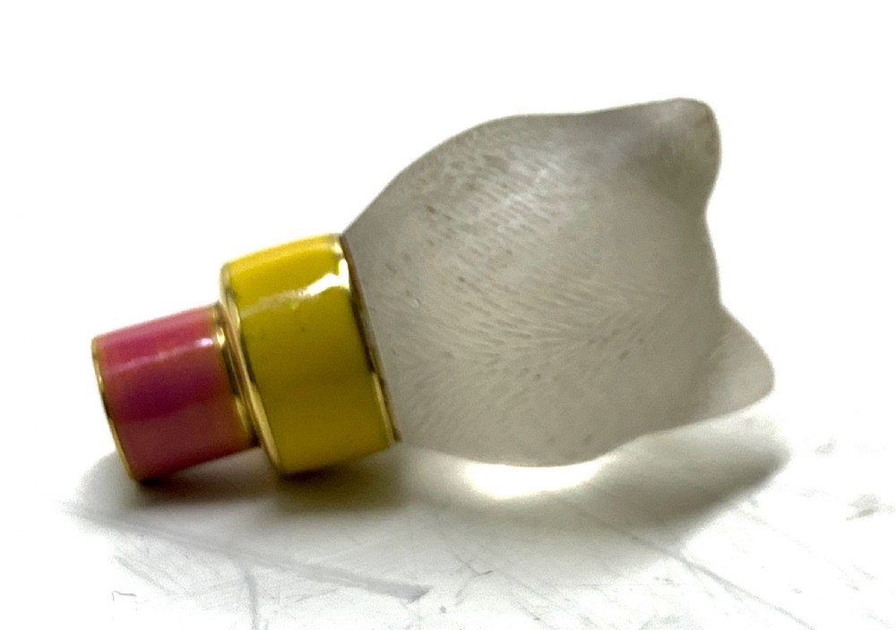 A carved frosted rock crystal cat head featuring green eyes, mounted atop an 18k gold collar with yellow and pink guilloche enamel. View XIV
