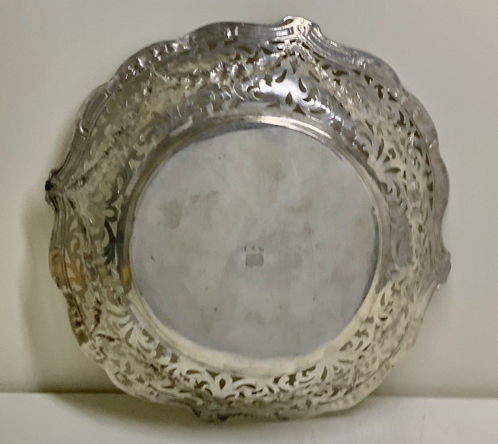 A circular antique solid silver bread basket featuring intricate hand-pierced fretwork, repousse floral swags, and a contoured scalloped rim. View VIII