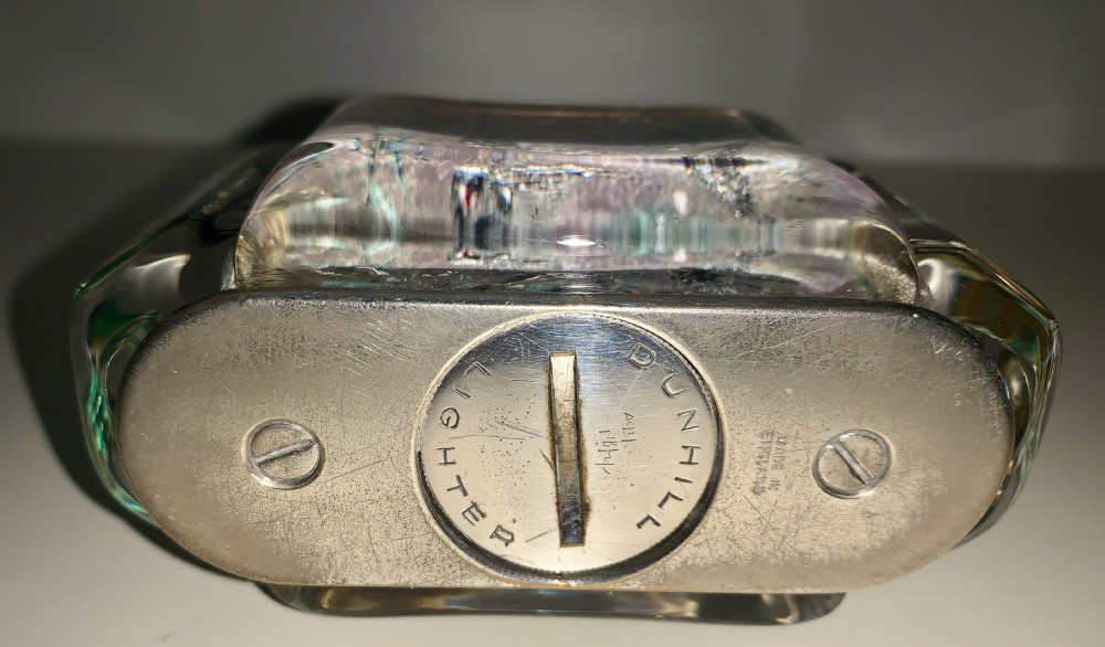 A mid-century Dunhill Aquarium table lighter featuring transparent acrylic panels reverse-carved with angelfish and aquatic plants beneath a silver-toned lift-arm mechanism. View X