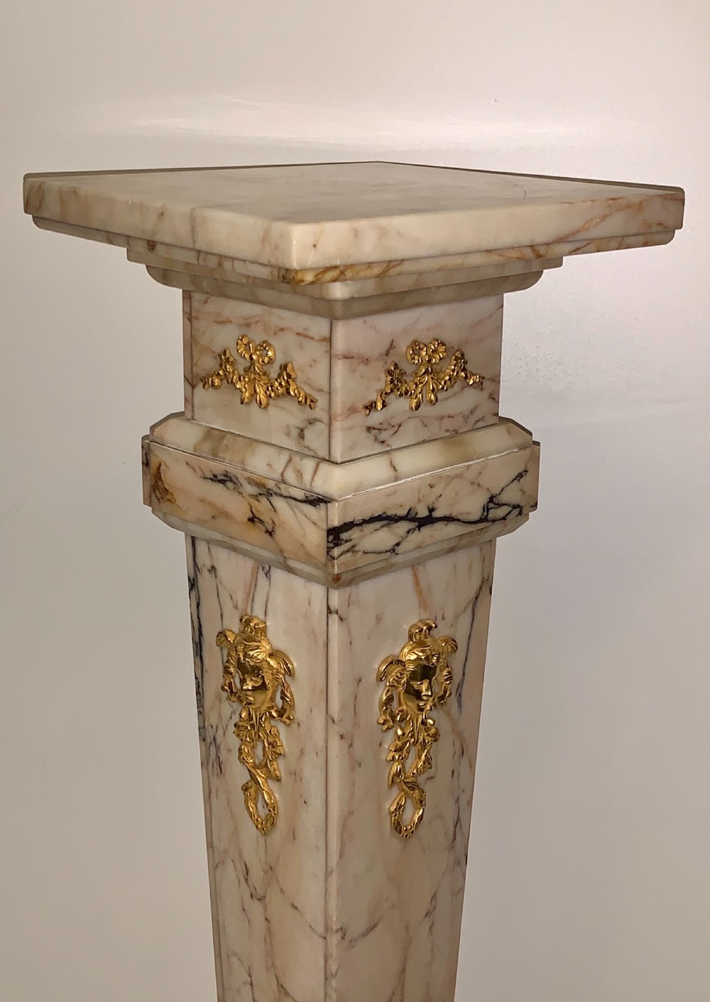 A tapered beige veined marble pedestal stand featuring ornate gilt bronze mounts and a square swivel top set upon a stepped base. View XI